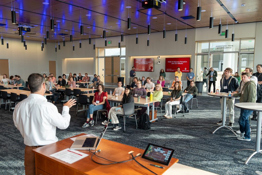 A large group of people listening to a presentation