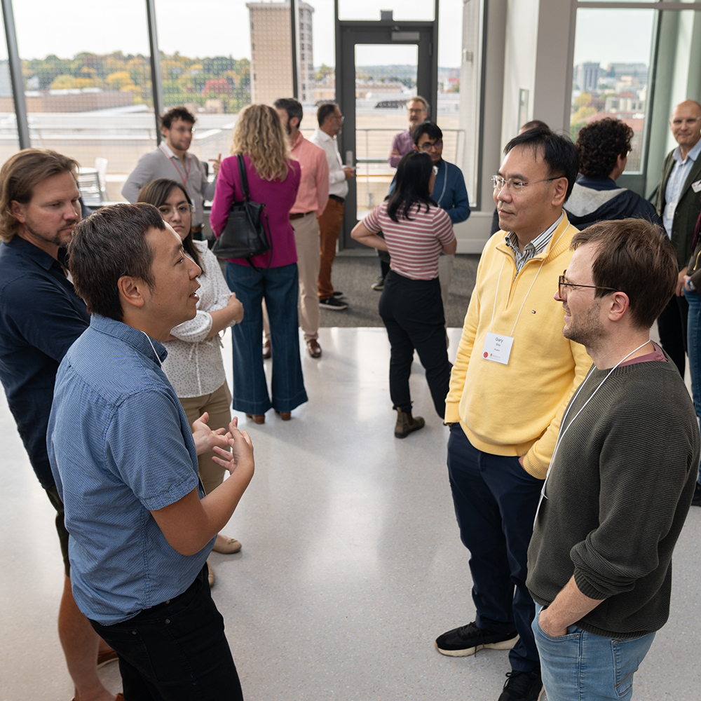 An image of DSI data scientists talking to researchers.