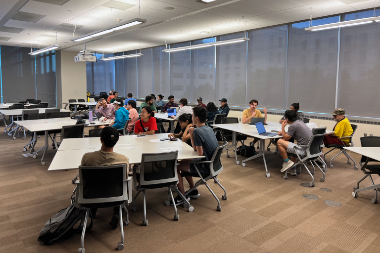 Groups of people sitting around tables.