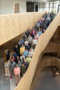Group photo of faculty and staff lined up on a staircase