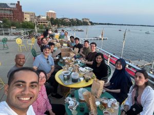 Workshop participants seated a a table on the Union Terrace overlooking the lake.