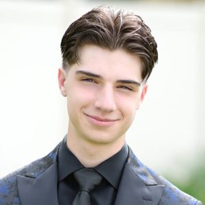 Photo of Vincent Lanzito. He has dark hair and is wearing a dark jacket and tie.