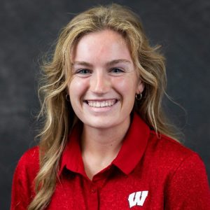 A head shot of Chloe Larsh. She has long blonde hair and she is wearing a red shirt.